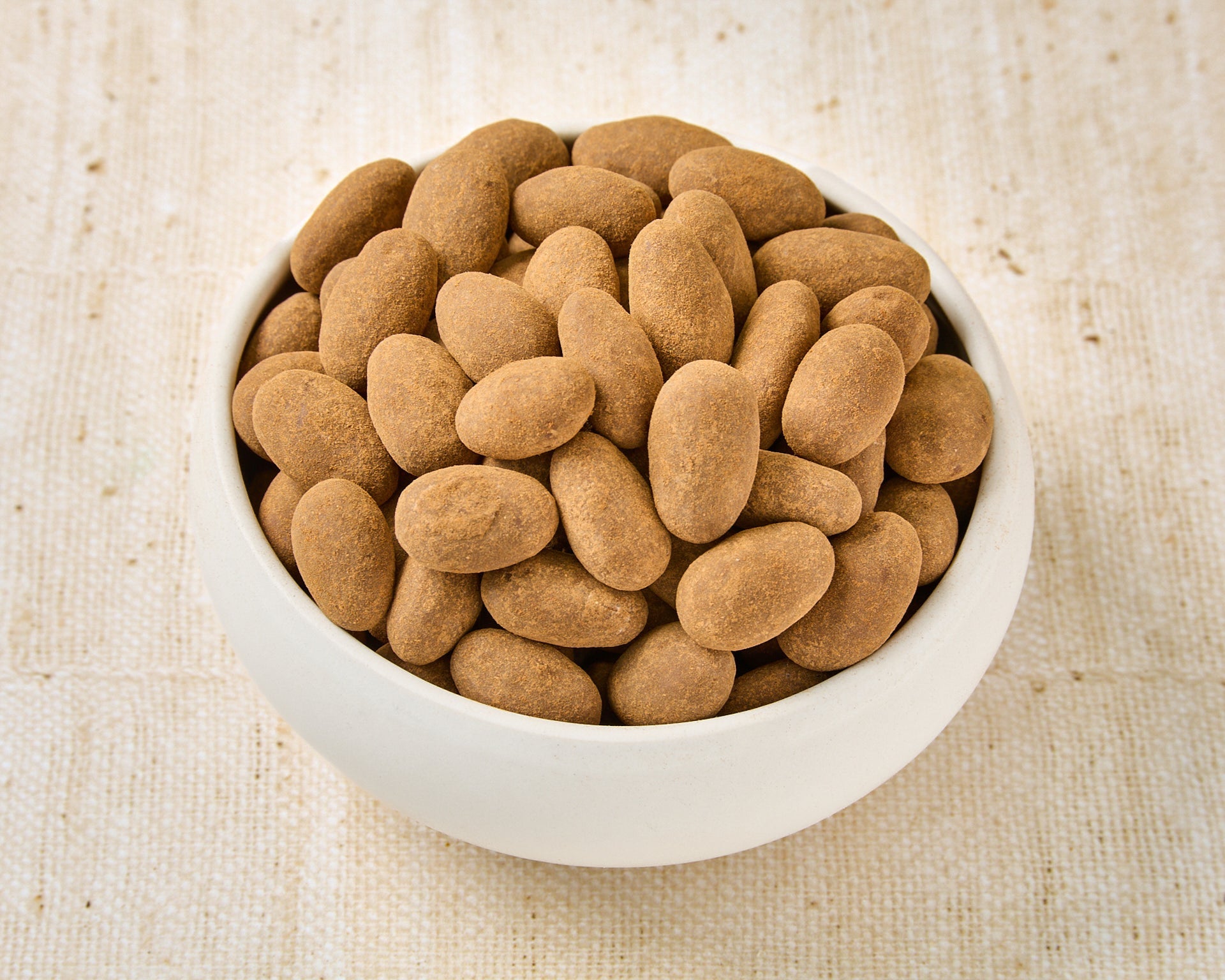 Almonds dipped in milk chocolate and cinnamon